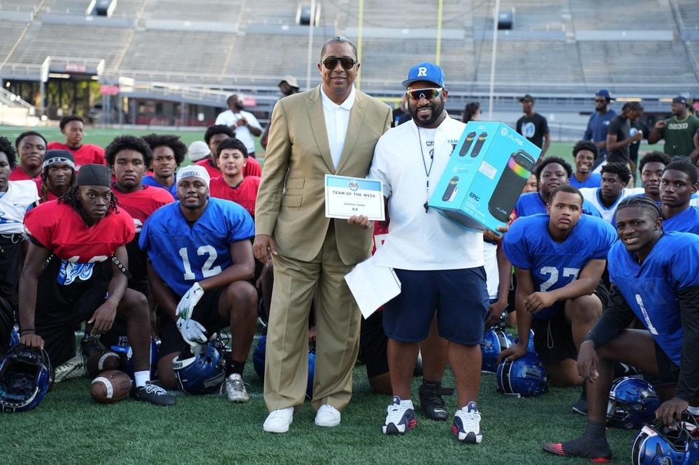 JLab Birmingham Bowl representative Jay Roberson presents Rams Coach Ronnie Jackson with certificate and JLab speaker