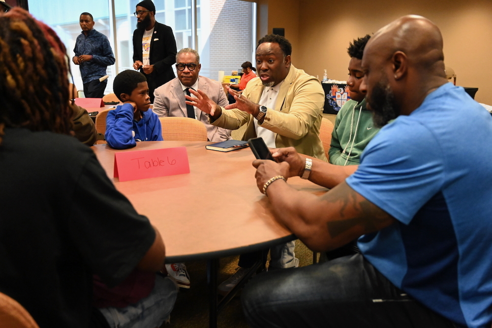 Board Member Derrick Billups speaks to scholars at the Young Men's Summit.