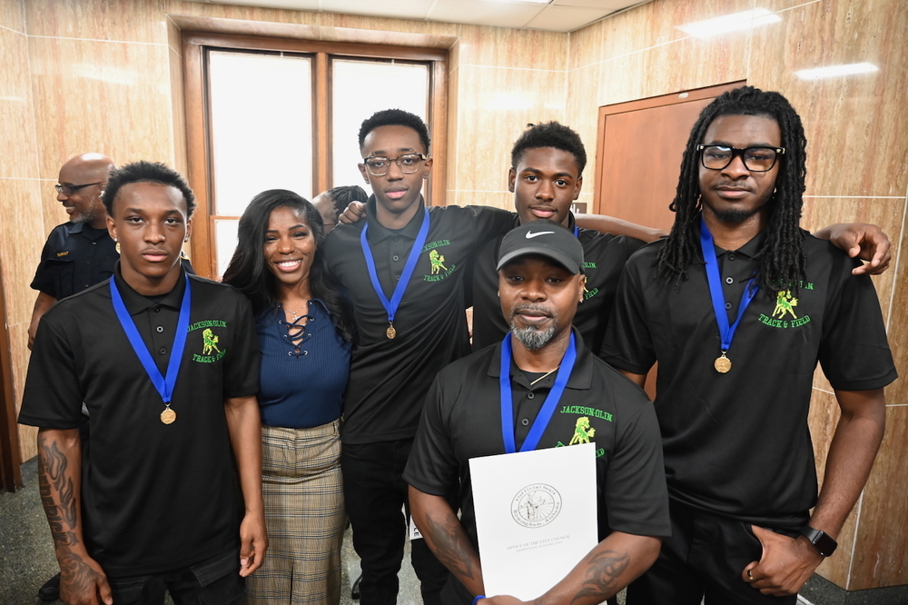 Jackson-Olin boys relay team with Board Member Yamika Foy