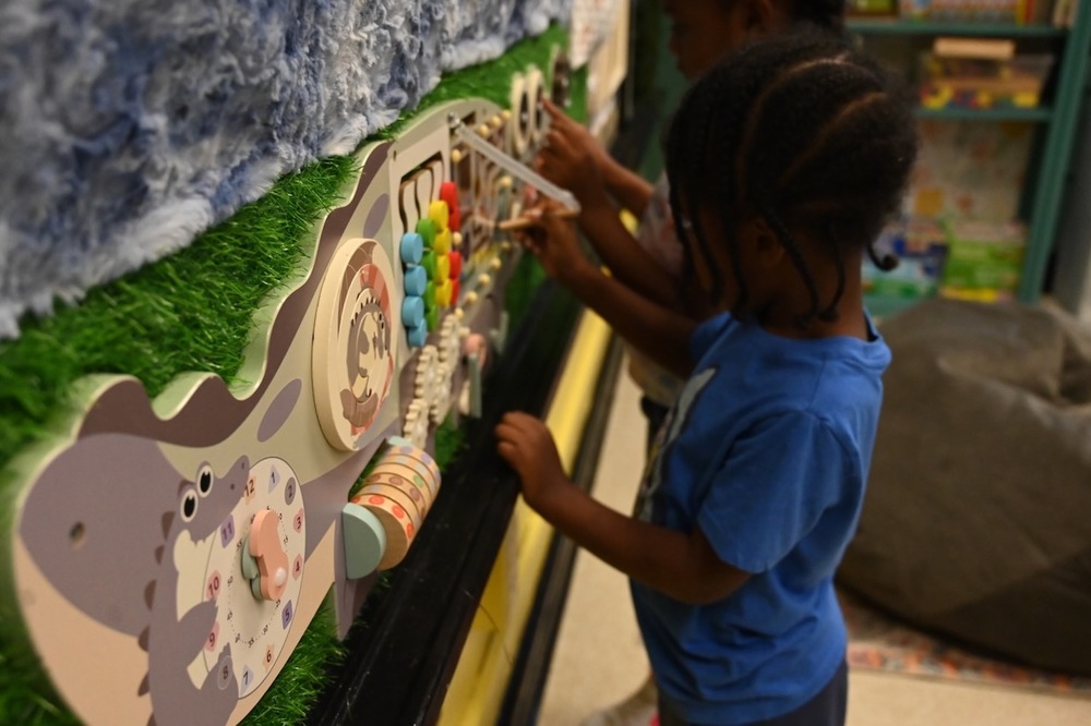Scholars at Minor Elementary School interact with a calming wall.
