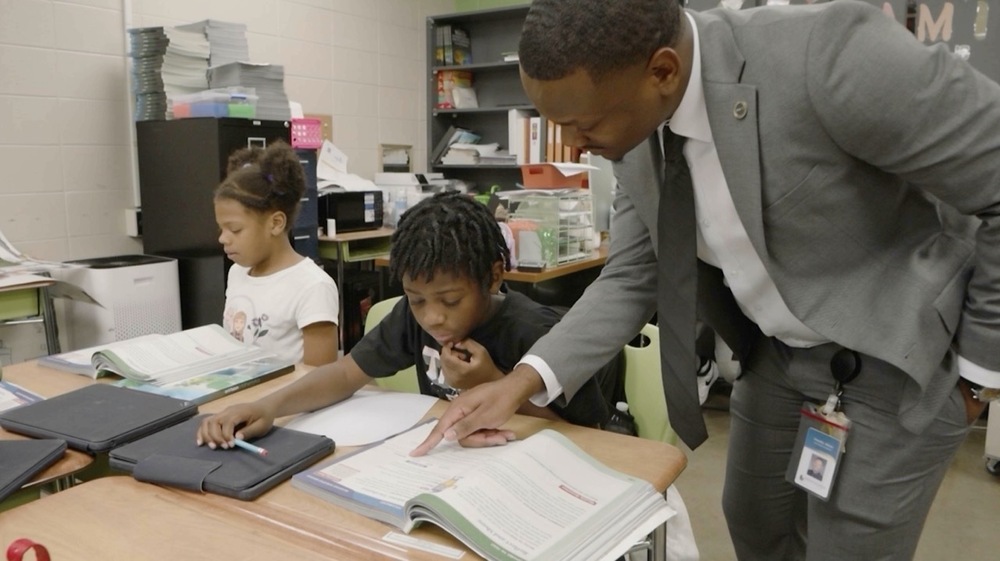 Dr. Timoth Allison helps a Huffman Academy scholar with his studies.