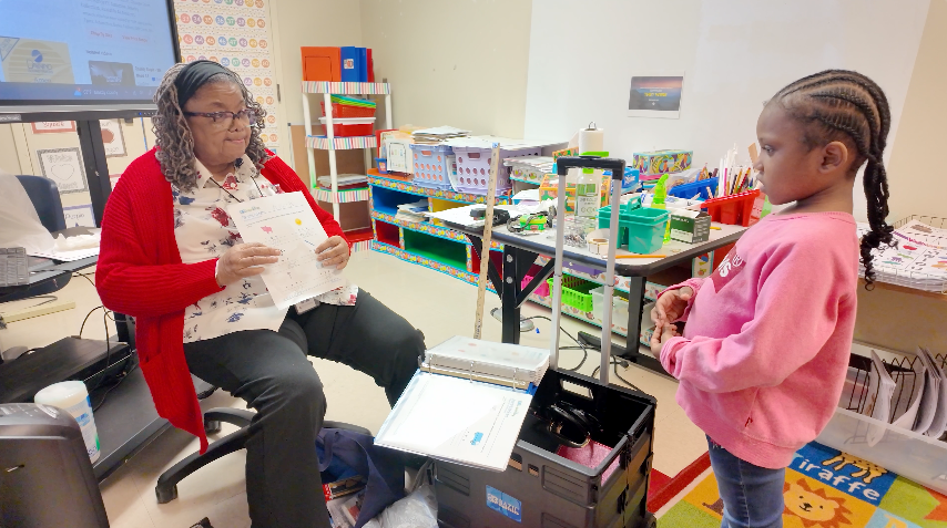 Janice Littleton works with a kindergartener at Phillips Academy. 