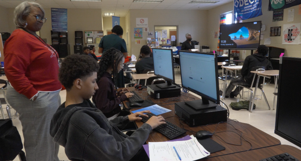 Instructor Yolanda Williams assists a student with a computer assignment,