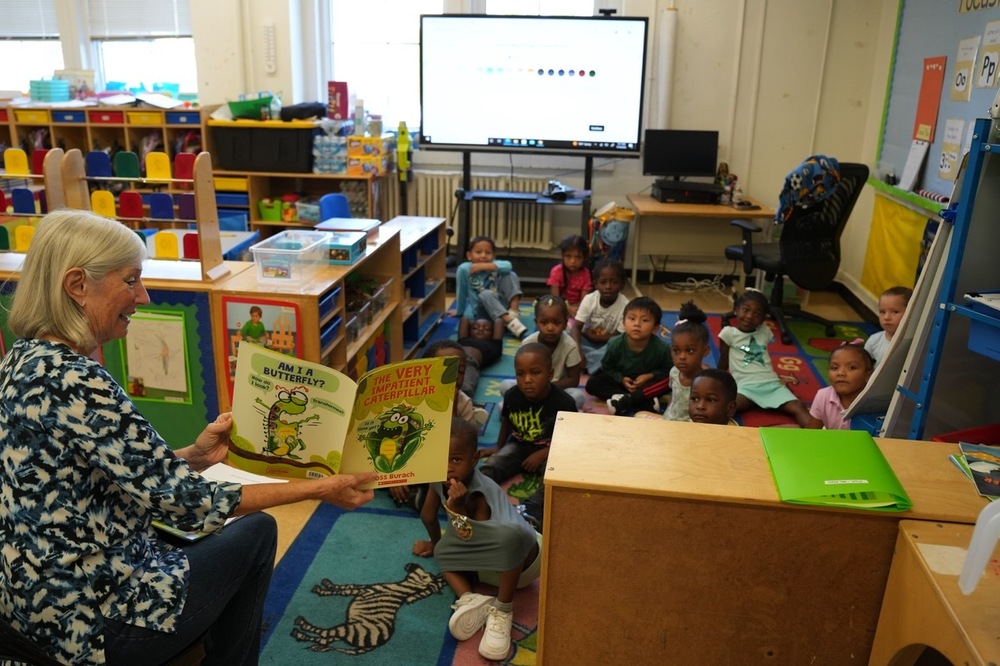 Board Member Mary Boehm reads to pre-K scholars at Barrett Elementary School.