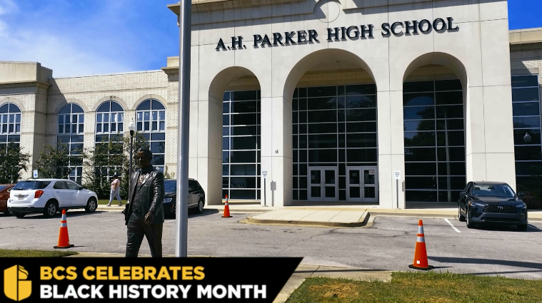 BCS Celebrates Black History Month: the facade of A.H. Parker High School with namesake statue in foreground