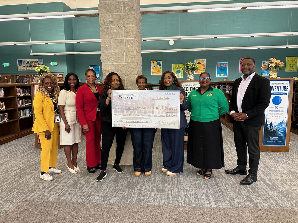 Council President Pro Tem LaTonya Tate presents a check for $6,500 to P.D. Jackson-Olin High School.
