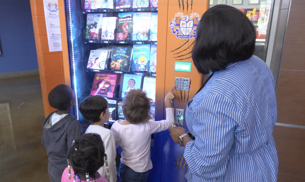 Students "purchase" books at the ;new book vending machine at Hayes K-8.