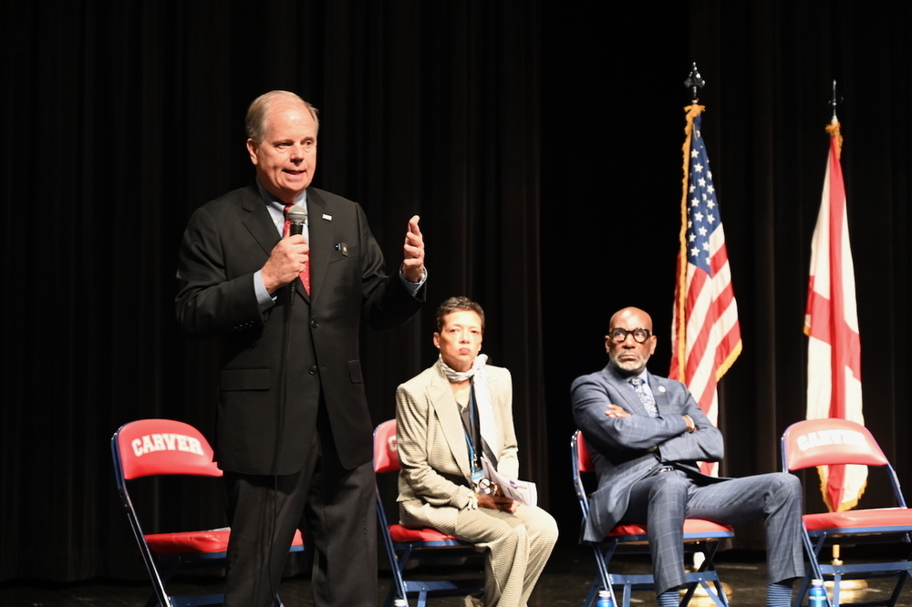 Doug Jones speaks as Carver Principal Tikki Hines and Superintendent Dr. Mark Sullivan look on. 