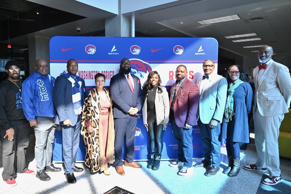 Coach Keon Handley (fifth from left), flanked by Principal Tikki Hines to the left and Board Member Yamika Foy to the right, BCS Athletic Director Henry Pope (fourth from right), BCS Operations Officer Michael Moore (far right) and other well-wishers