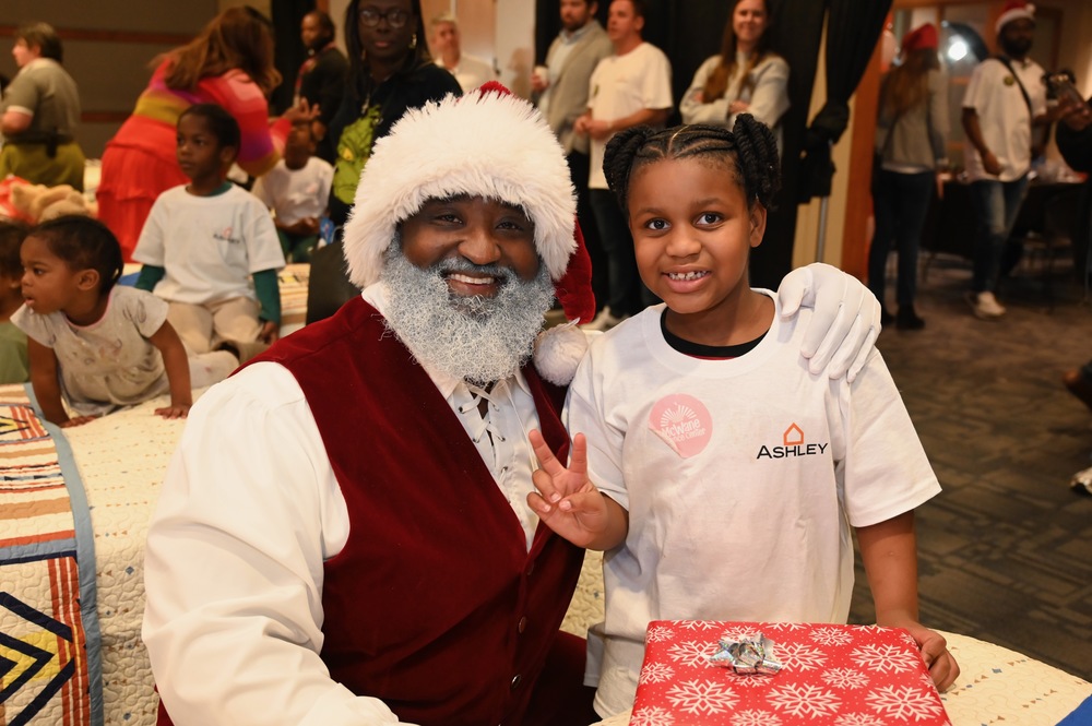 Santa gives a BCS scholar a new bed and a present for Christmas.