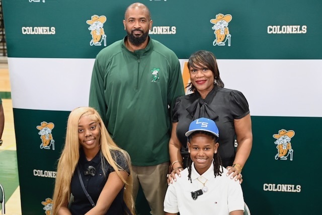 Players pose for a photo with their principal and coach