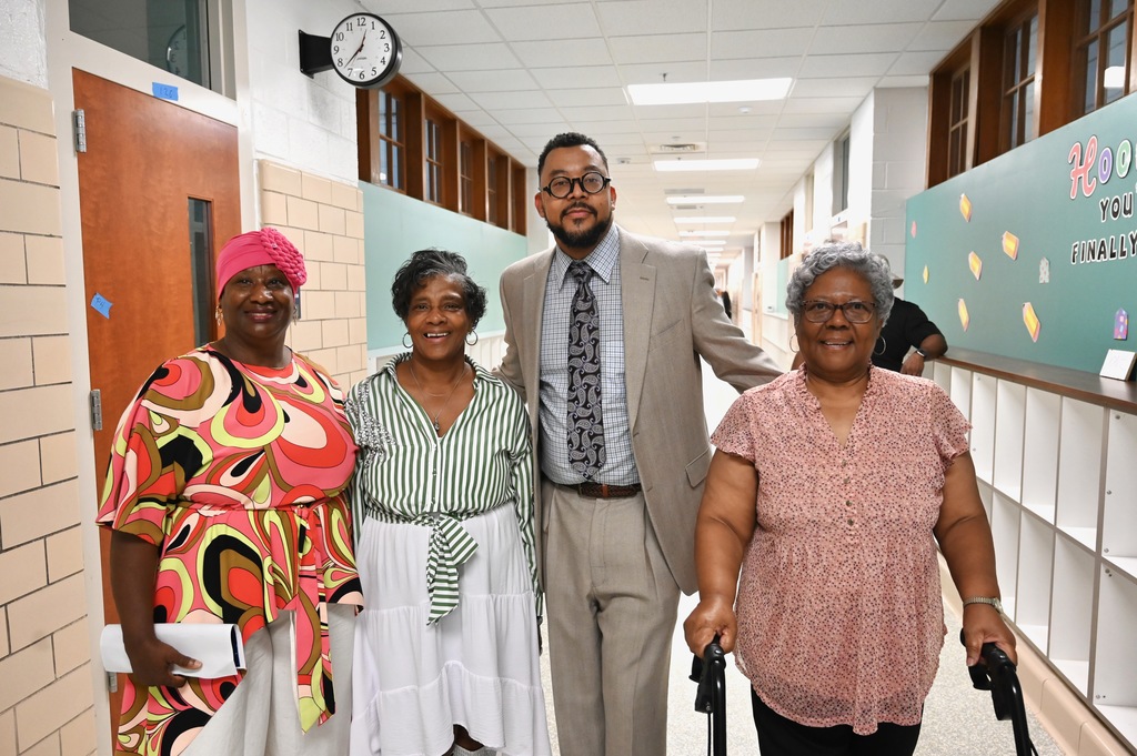 Assistant Principal Dr. Taylor Greene greets community members.