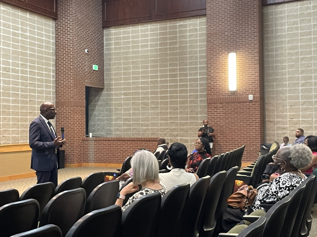 Dr. Mark Sullivan speaks with attendees at the Strategic Plan Update Meeting at Huffman High School