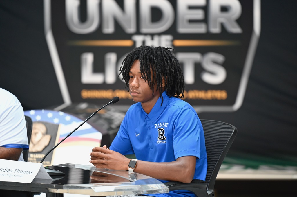 Alandias Thomas listens to the media as they ask their questions.