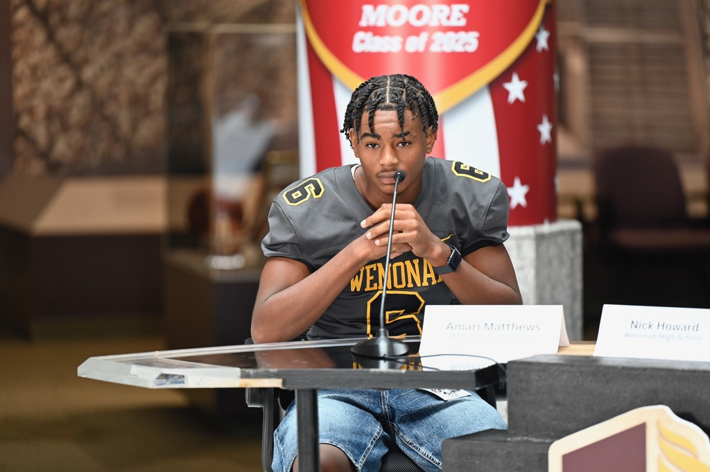 Amari Matthews looks on.