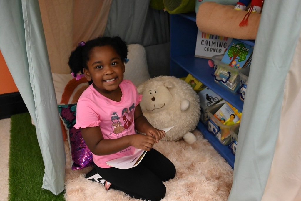 A Minor Elementary scholar enjoys the new resource room