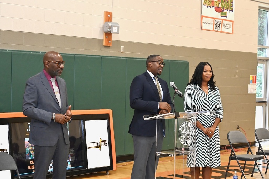 Dr. Mark Sullivan and Goodr CEO Jasmine Crowe-Houstong look on as Councilor Clinton Woods speaks