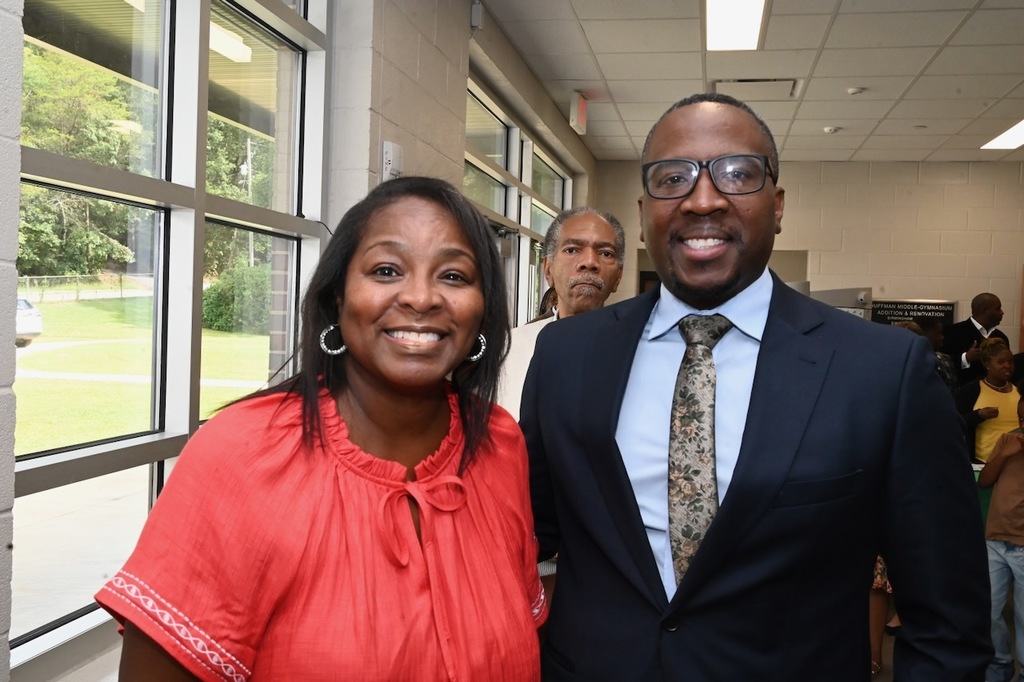 Councilor Clinton Woods (right) poses with a community member.