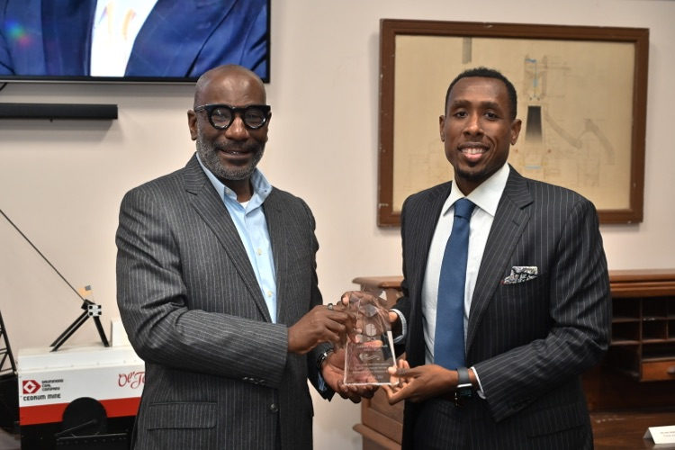 Dr. Mark Sullivan presents a trophy to Board President Jason Meadows