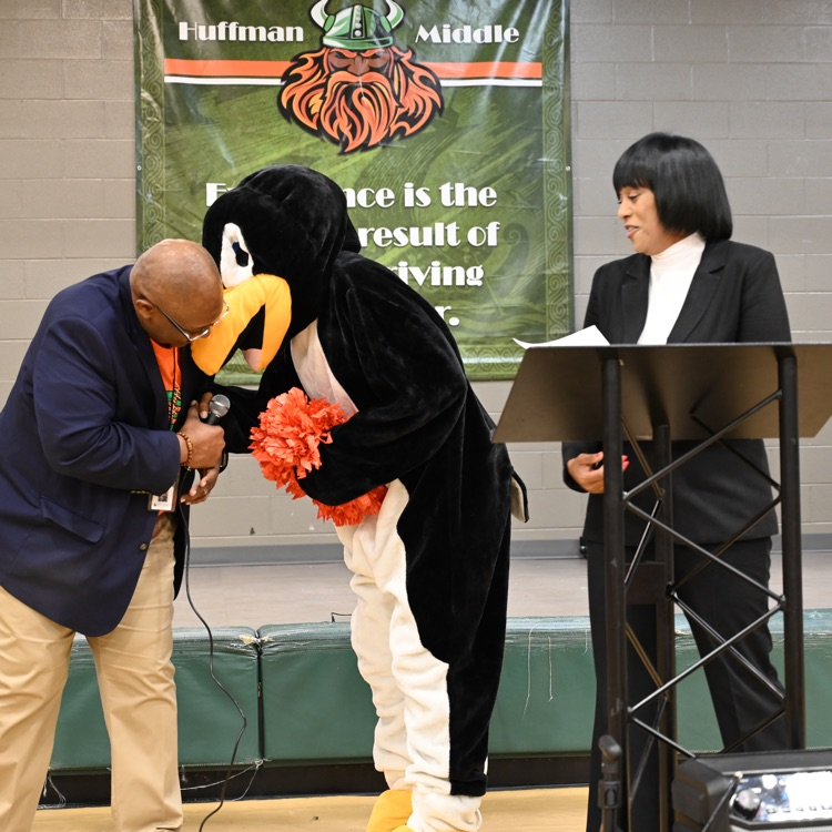 Principal Jeffrey Willis plays with the mascot