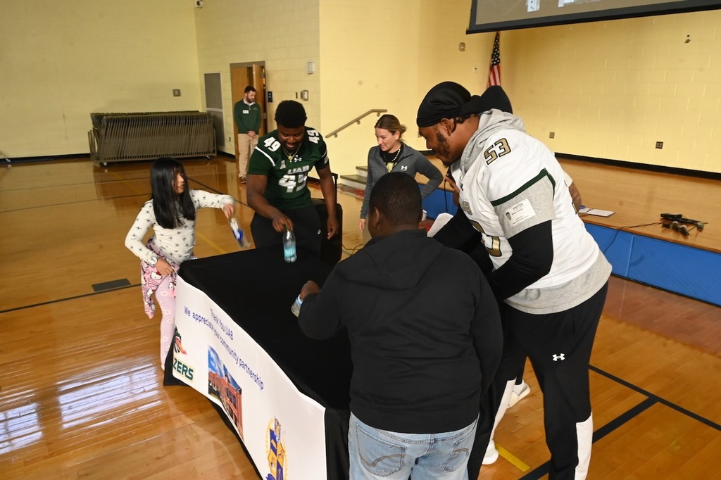 Anna Mondragon (far left) and Darion Mack (second from right) played flip bottle with the UAB players!