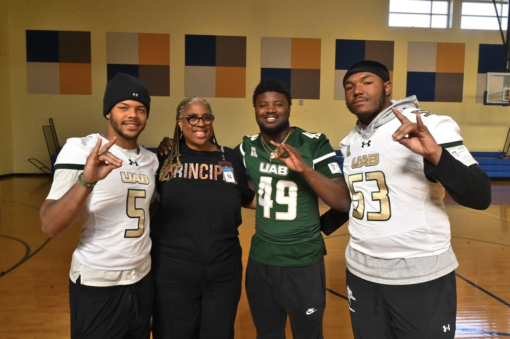 Kaleb Brown #5 Jacoby Bridges 49 and Parker Baron Franks 53 with Tuggle Principal Elizabeth Chiles
