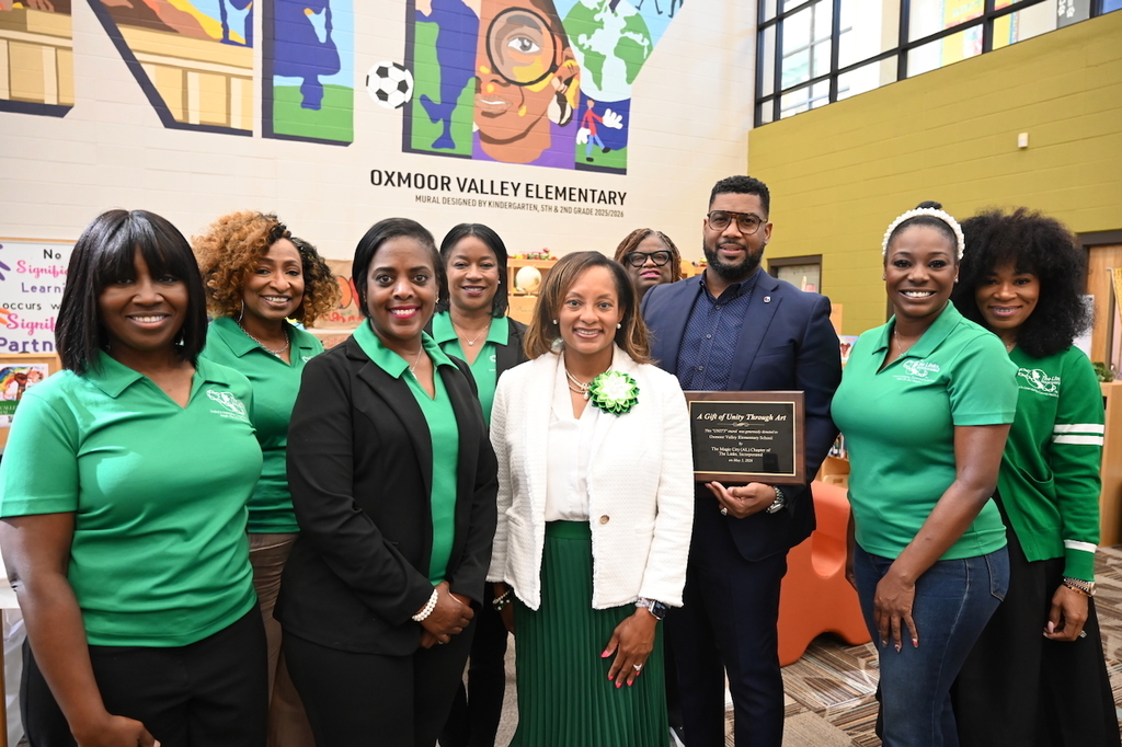 The Magic City (AL) Chapter of The Links, Incorporated present Oxmoor Valley Elementary School Principal Dr. Melvin Love with a plaque commemorating the new mural.