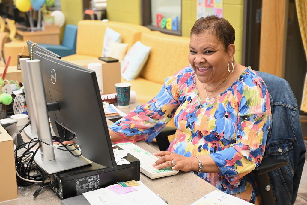 BCS Librarian of the Year Tamra Isman is all smiles about the new mural in her workspace!