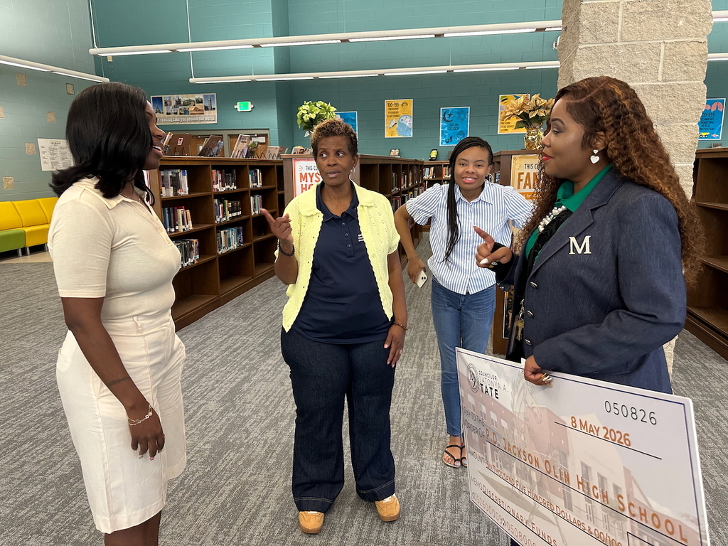 Council President Pro Tem LaTonya Tate chats with Board Member Yamika Foy and Jackson-Olin Interim Principal Toyal McLain.