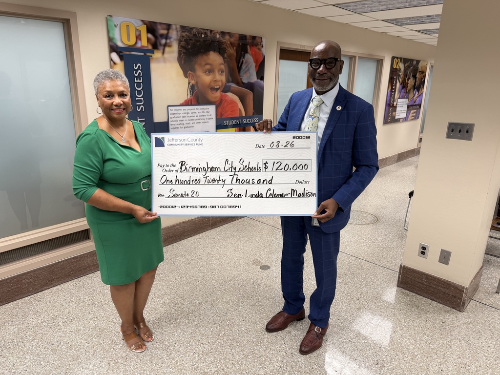 Senator Linda Coleman-Madison presents a check for $120,000 to Superintendent Dr. Mark Sullivan