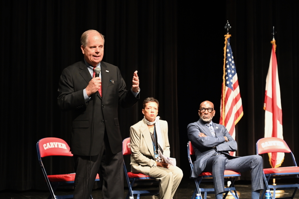 Alabama Gubernatorial Candidate and former U.S. Senator Doug Jones speaks while Principal Tikki Hines and Superintendent Dr. Mark Sullivan look on