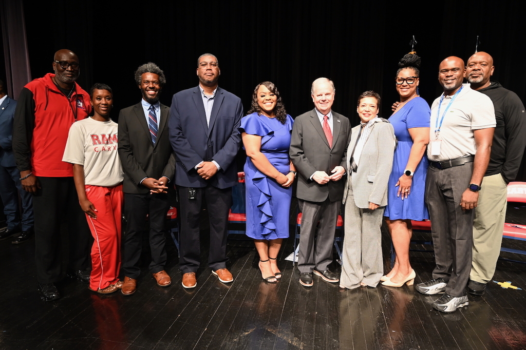 Doug Jones poses for a photo with Carver faculty and Principal Tikki Hines