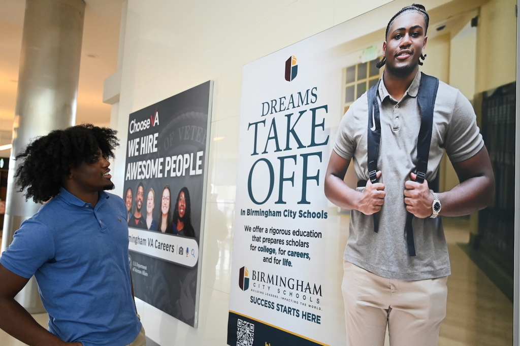 Ramsay's Chase Holt and his billboard at Birmingham-Shuttlesworth International Airport