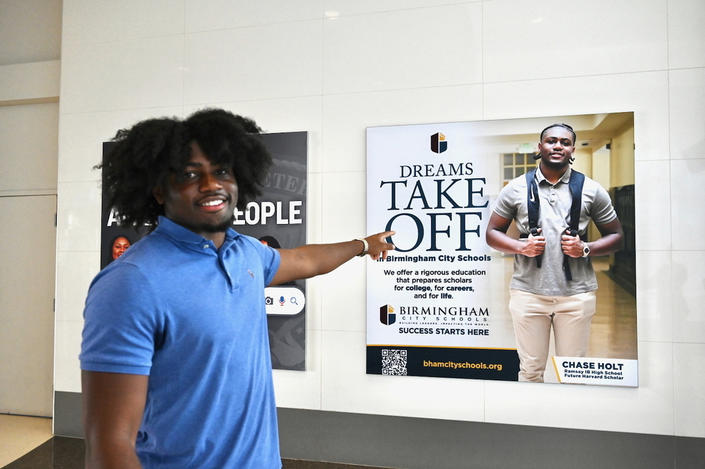Ramsay's Chase Holt and his billboard at Birmingham-Shuttlesworth International Airport