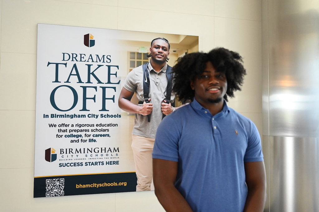 Ramsay's Chase Holt and his billboard at Birmingham-Shuttlesworth International Airport