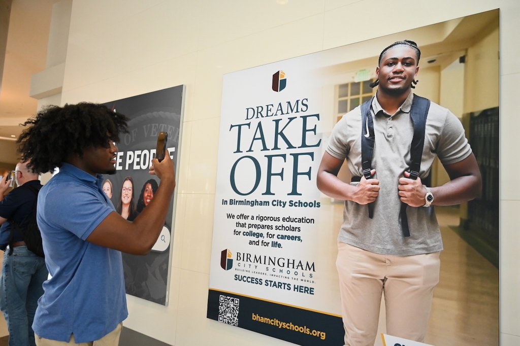 Ramsay's Chase Holt and his billboard at Birmingham-Shuttlesworth International Airport