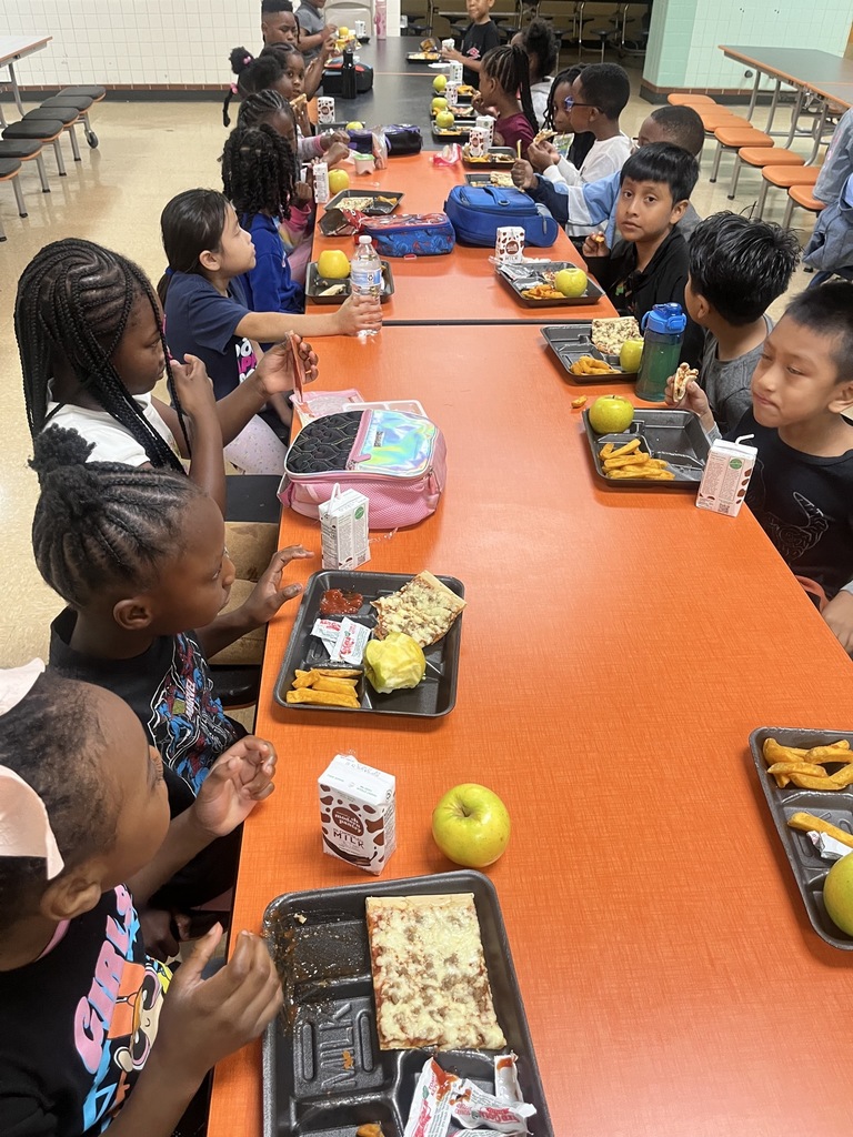 students eating lunch at lunchroom tables
