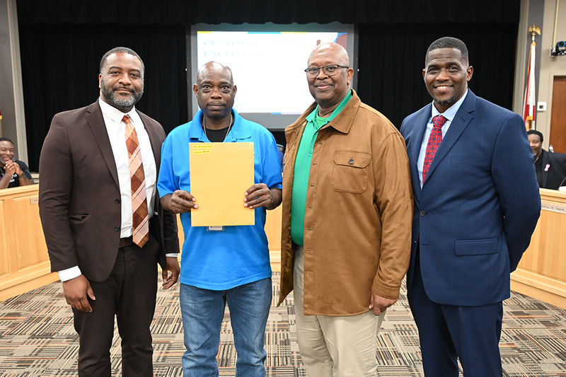 Chief of Staff Dr. Terry Lamar, Anthony Starks and Principal Jeffrey Willis of Huffman Middle School, and Board Member Sherman Collins