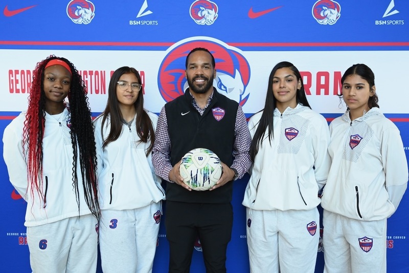 Coach Aubrey Bennett (center) with team members of the Carver Lady Rams soccer team