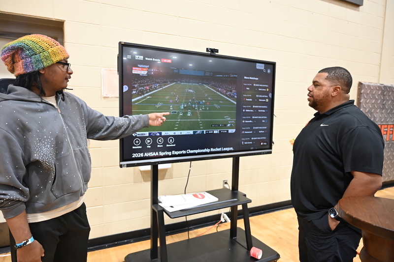 Carlos Smith, Jr. reviews his championship game footage with Coach Justin Hackett