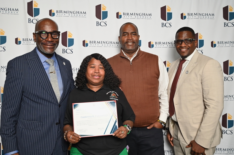 Superintendent Dr. Mark Sullivan, Huffman's Contessa Cummings and Principal John Lyons, Board President Sherman Collins