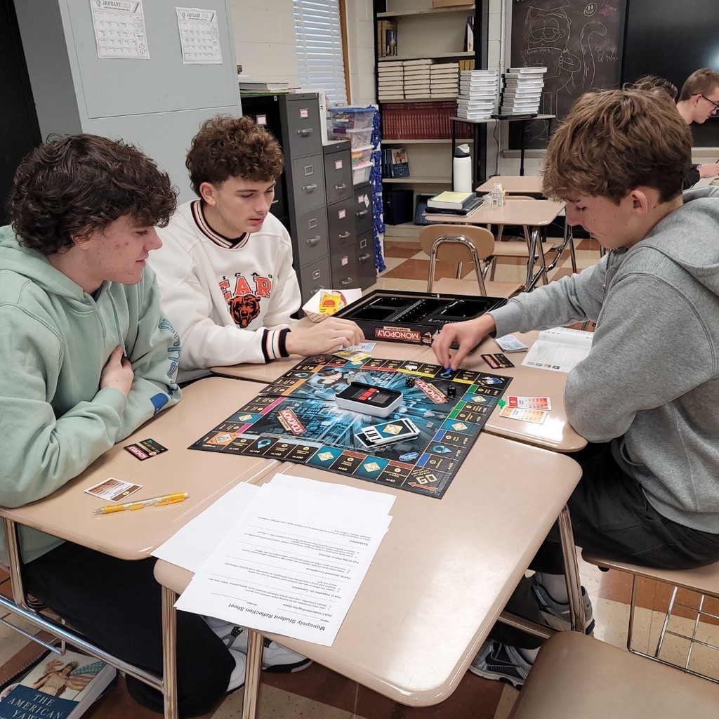 Mason C, Daron F. and Gabriel R. participate in the Monopoly experiment.