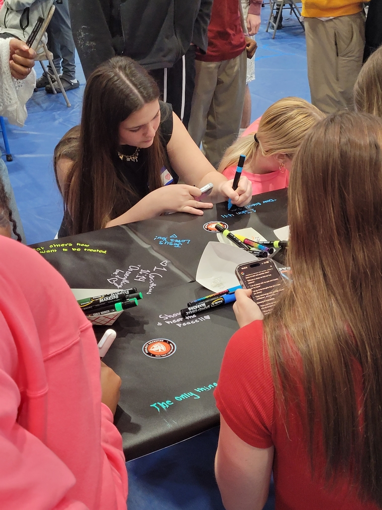 Lahna B. adds to the Peace Poster.