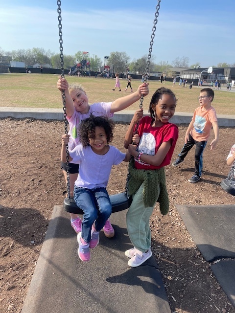Judy gets a push on the swing from some 1st grade friends.