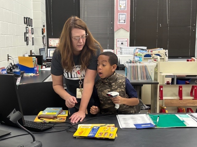 Kingston helping Mrs. Hall in the library