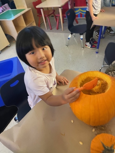 Pumpkin carving in Pre-K, Mrs. Beach