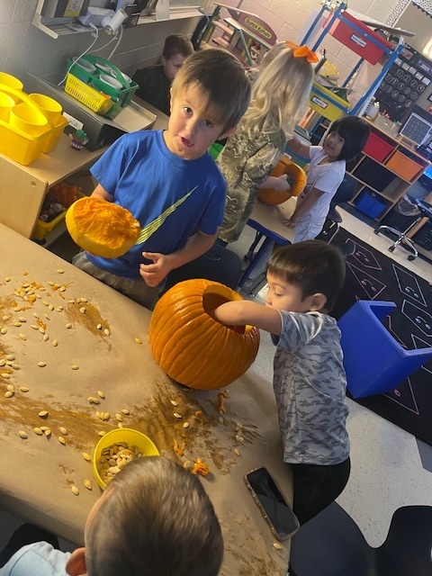 Pumpkin carving in Pre-K, Mrs. Beach