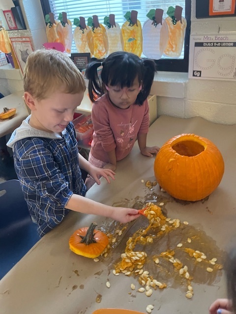 Pumpkin carving in Pre-K, Mrs. Beach