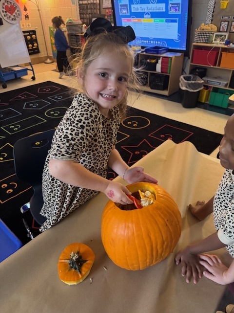Pumpkin carving in Pre-K, Mrs. Beach