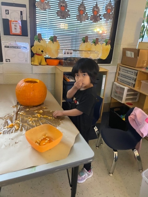 Pumpkin carving in Pre-K, Mrs. Beach